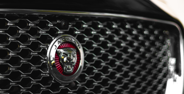 Close up image of the Jaguar badge on the front of a black car